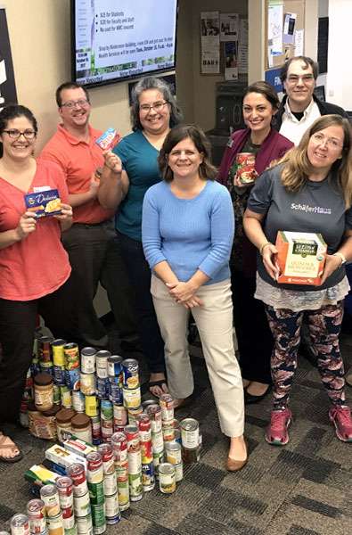 Photo of food pantry volunteers and donations