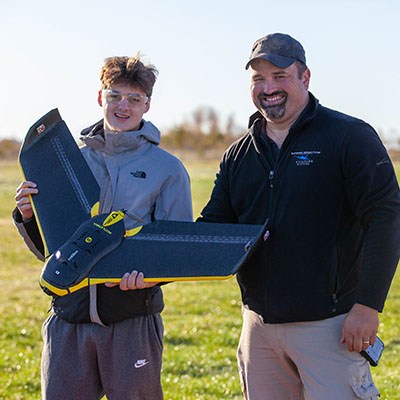 An NMC UAS program student and instrictor show off a drone