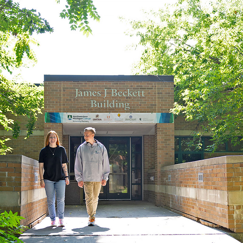 NMC University Partners students walking outside the James Beckett Building on NMC's Front Street campus