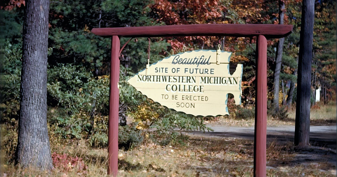 A wooden sign for the future site of NMC