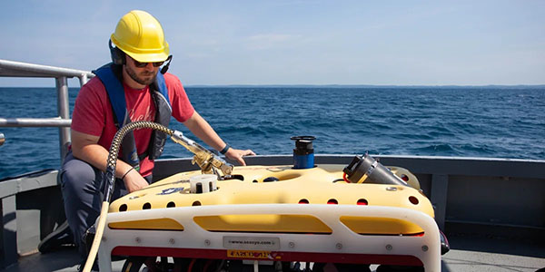 A Marine Technology program student prepares to launch a remotely-operated vehicle off NMC's research vessel Northwestern